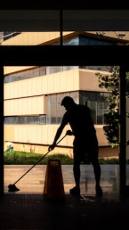 cleaner with a mop silhouette