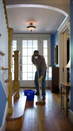 person cleaning in ground floor of a house