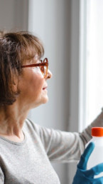 person cleaning window with disinfectant